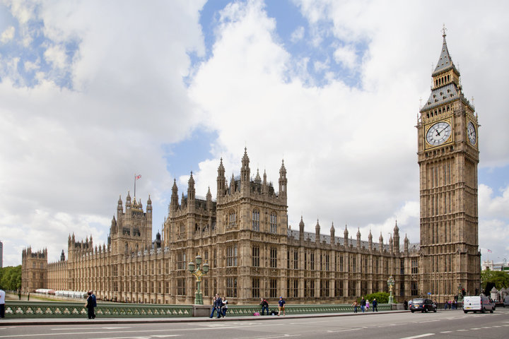 houses of parliament with clouds in a blue sky